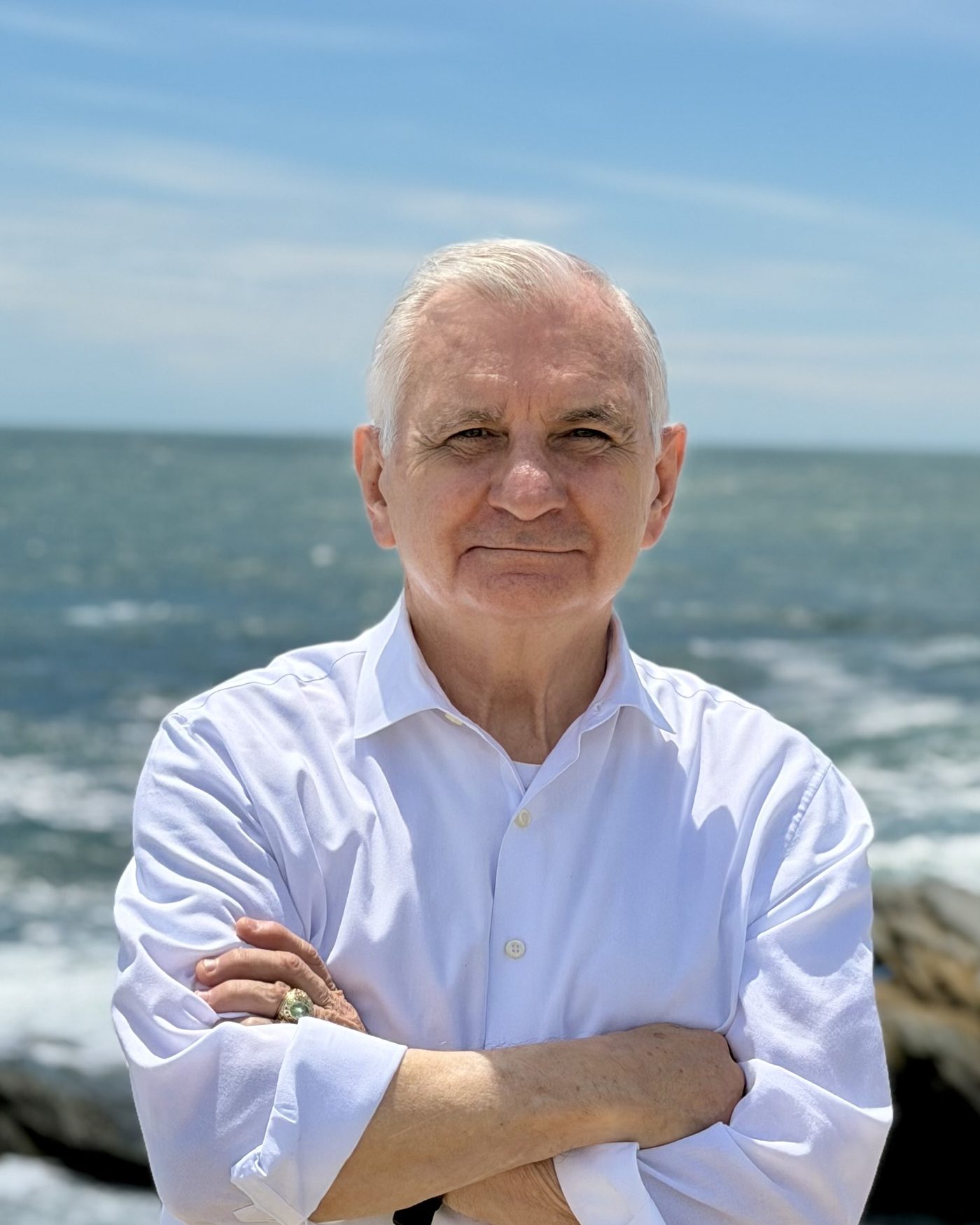 Jack Reed with arms crossed on the Rhode Island shoreline